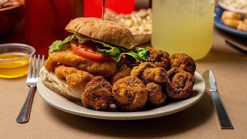 Fried fish sandwich with side of fried calamari