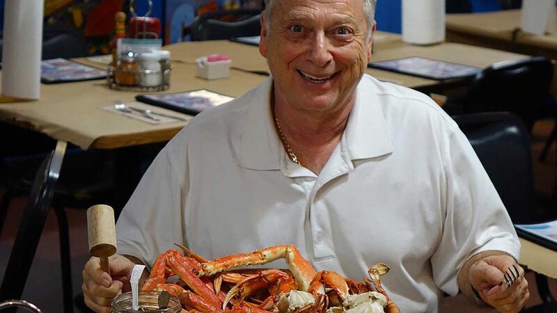 Norman smiling with a plate of crabs