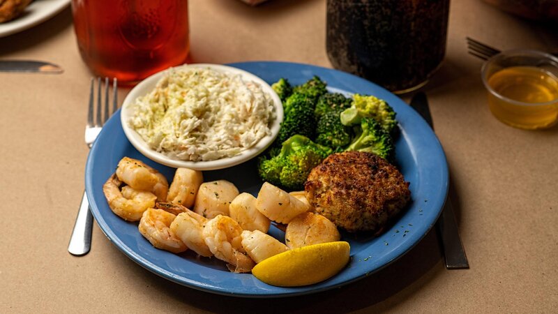 Shrimp and mussels with a side of coleslaw, broccoli and hushpuppy